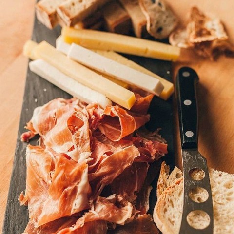 a board of ham cheese and bread