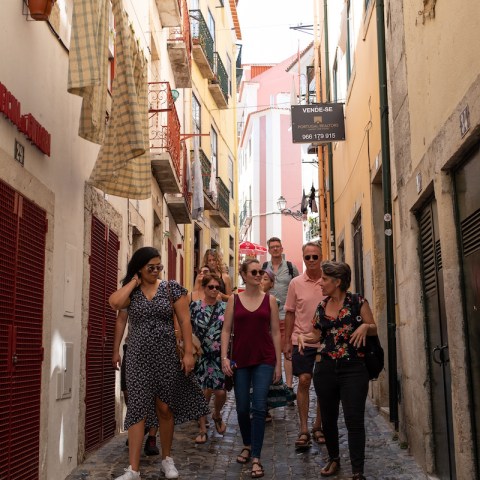 a group of people walking in Alfama streets