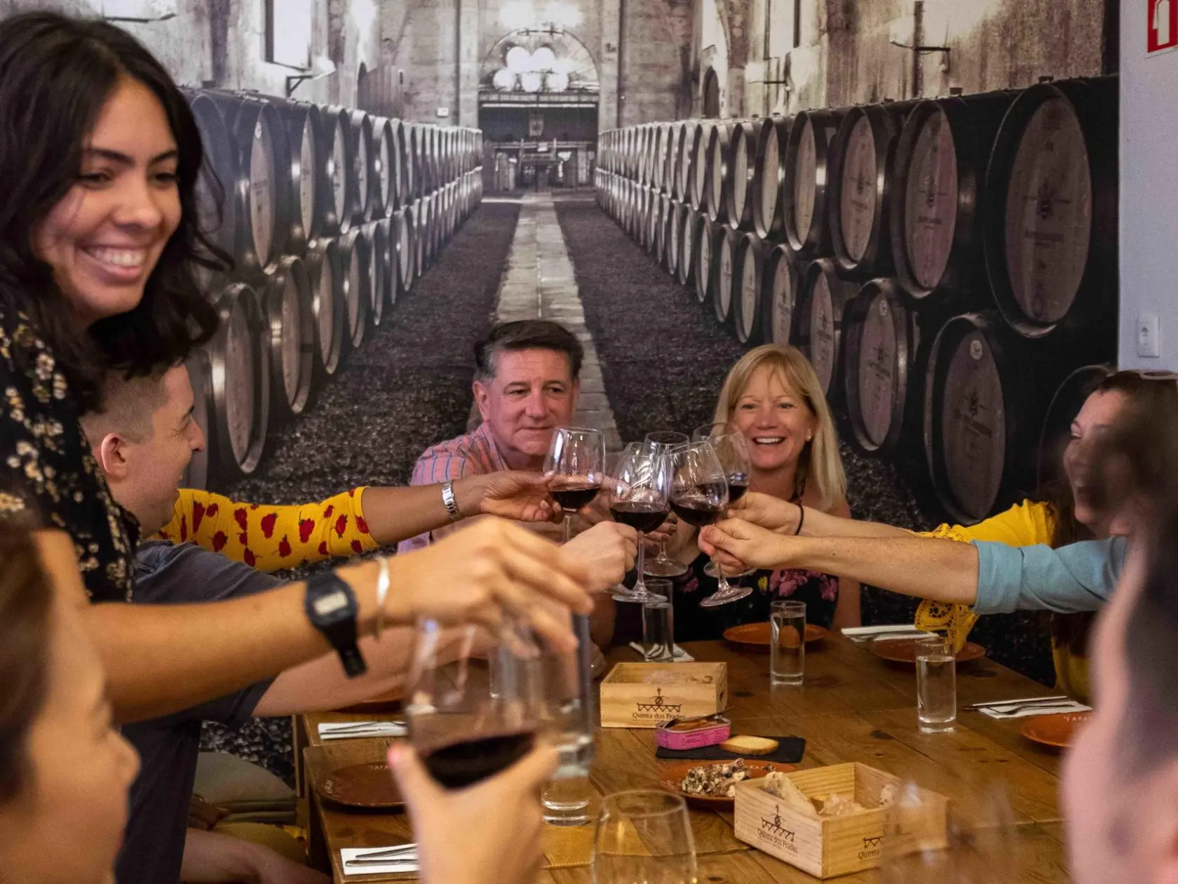 a group of people are drinking from a wine glass