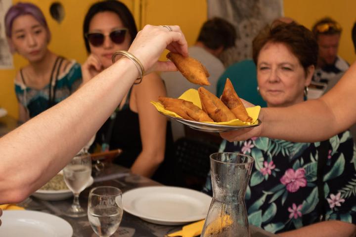 a group of people sitting at a table eating food