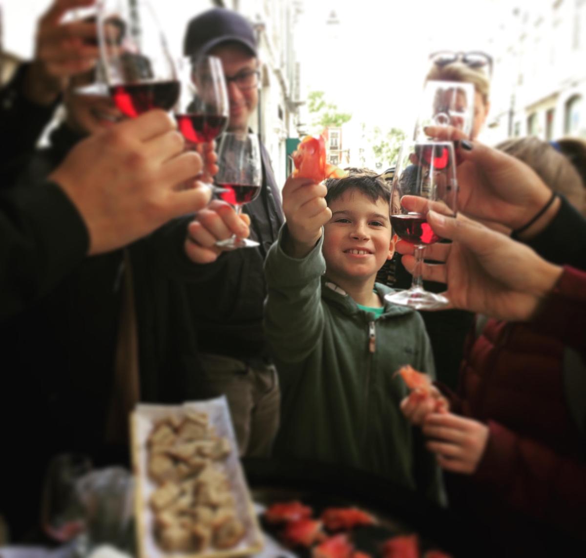 Portuguese Cuisine: 17 Tastings Lisbon Food Tour Image 9 a person holding a glass of wine