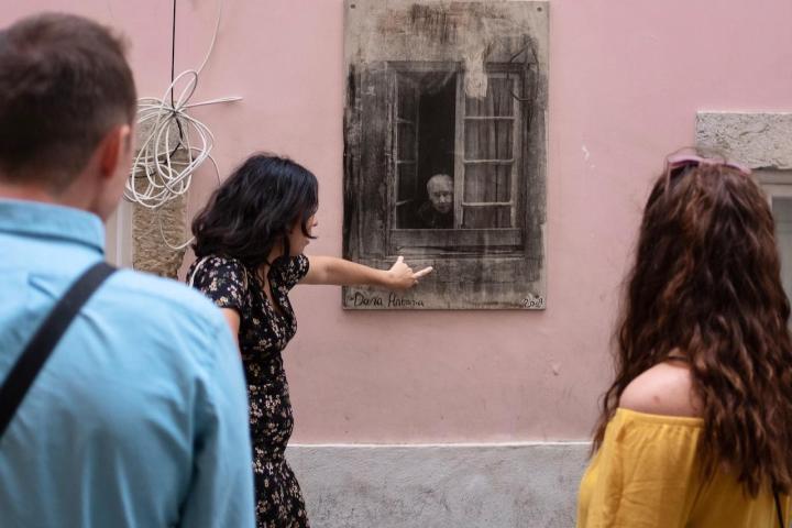 a man and a woman standing in front of a building