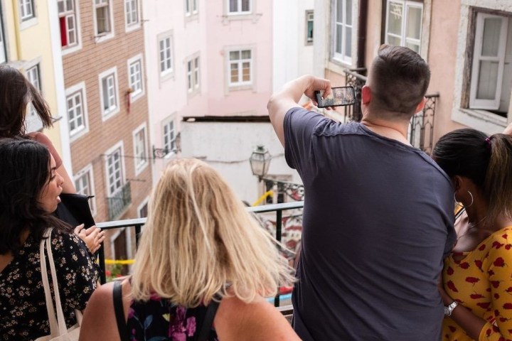 a group of people looking at a cell phone