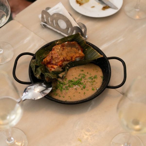 a plate of food and glasses of wine on a table