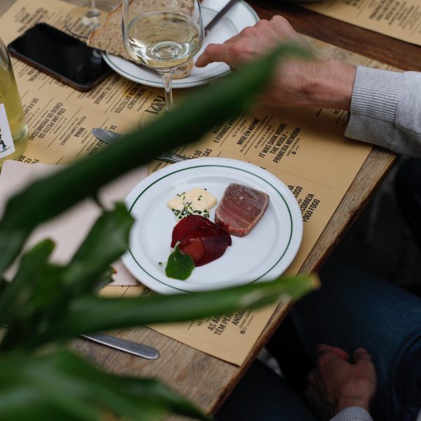 a group of people sitting at a table with a plate of food