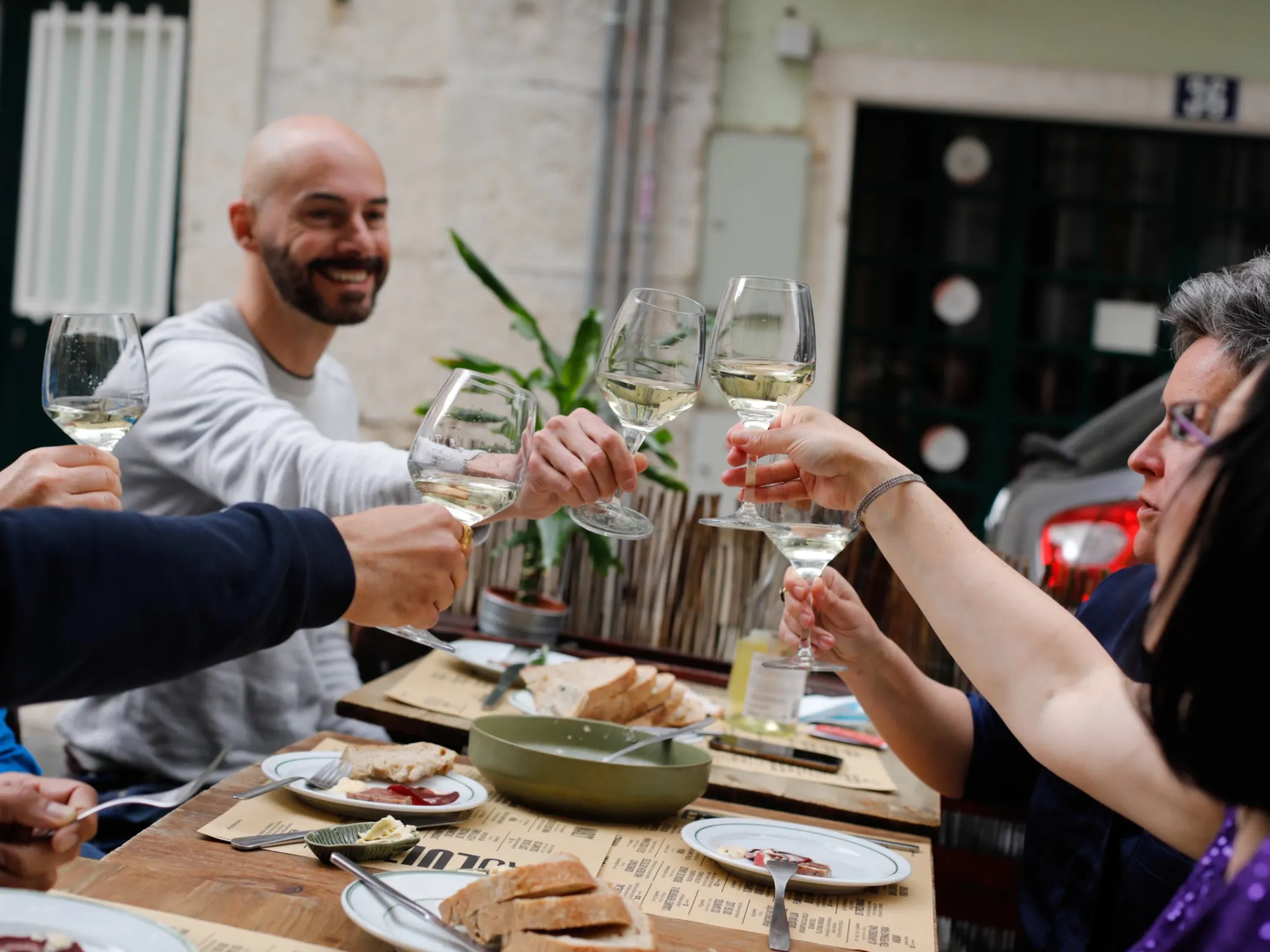 a group of people sitting at a table with food