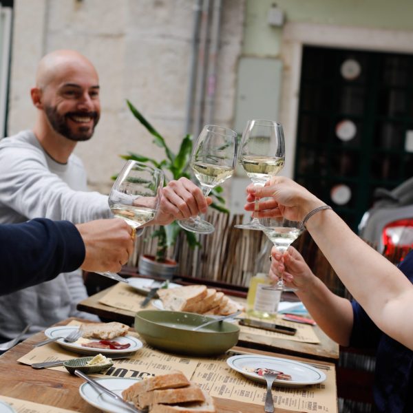 a group of people sitting at a table with food
