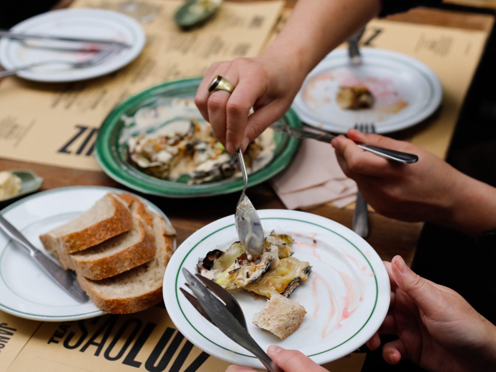 a group of people sitting at a table with a plate of food