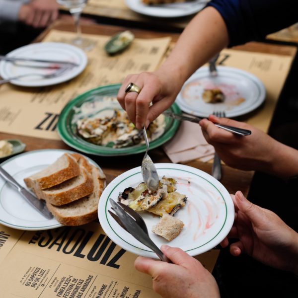 a group of people sitting at a table with a plate of food