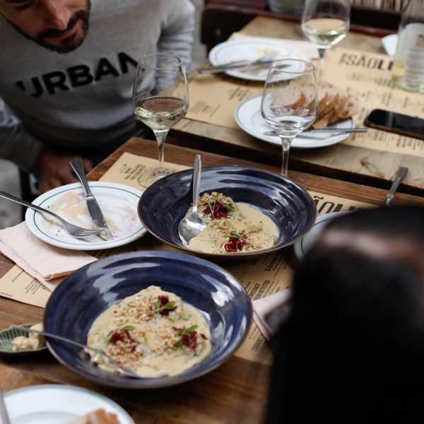 a person sitting at a table with a plate of food