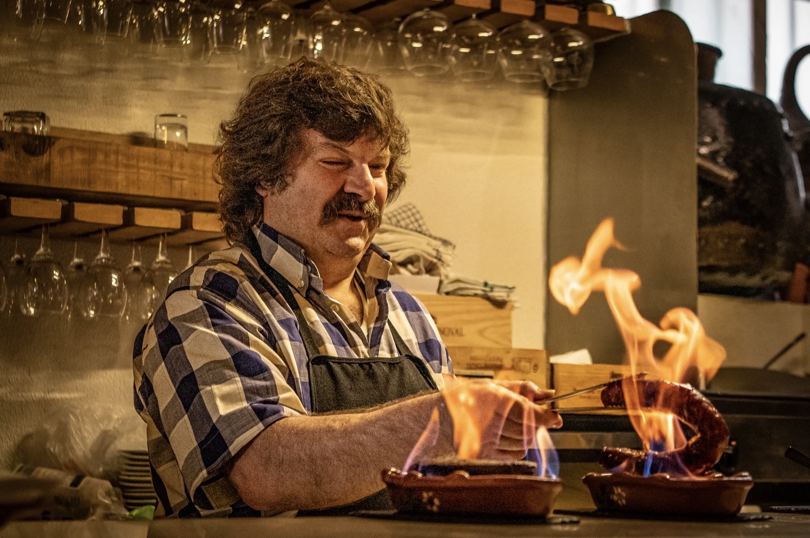 chourico-portuguese-17-tastings a man grlling chourizos