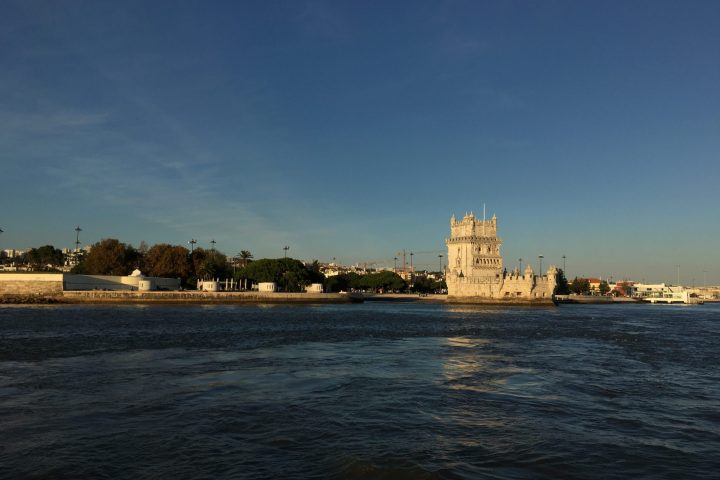 a large body of water with a city in the background