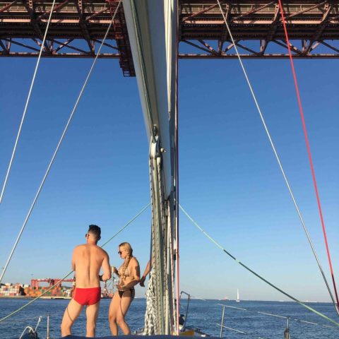 a group of people on a bridge over a body of water