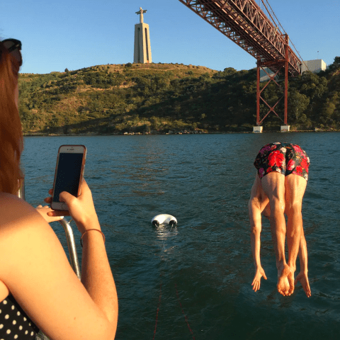 a woman standing in front of a body of water