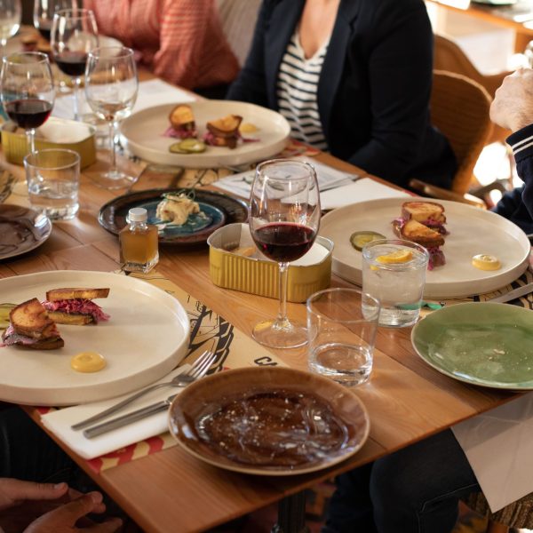 a group of people sitting at a table eating food
