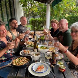 a group of people sitting at a table eating food