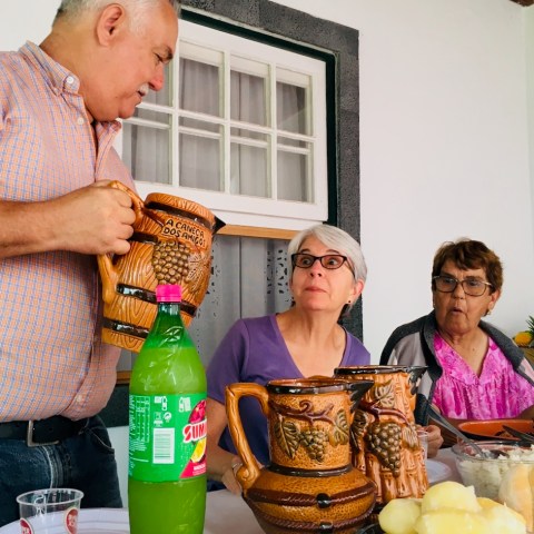 a man and a woman sitting at a table with food