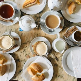 a plate of food and a cup of coffee