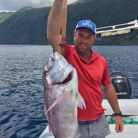 a man holding a fish