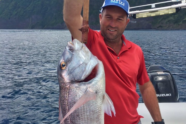 a man holding a fish