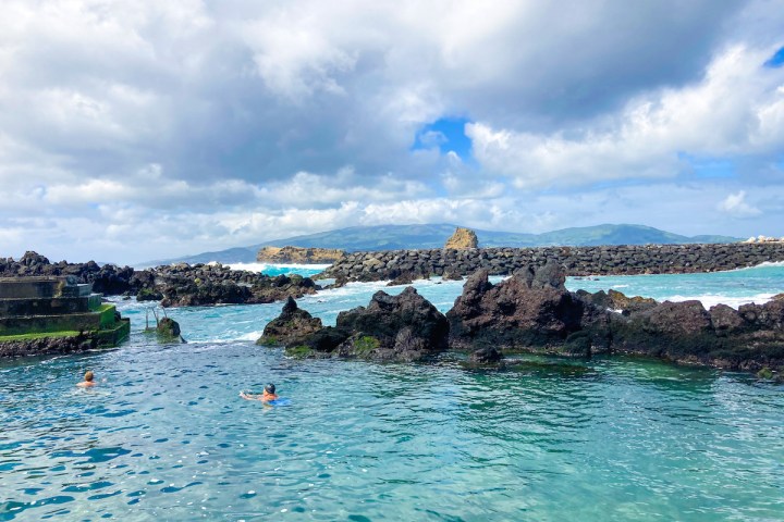 a group of people swimming in a body of water