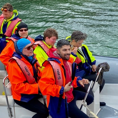 a group of people on a raft in a body of water