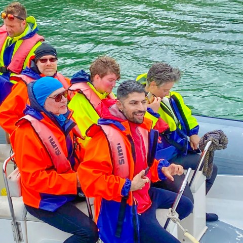 a group of people on a boat in the water