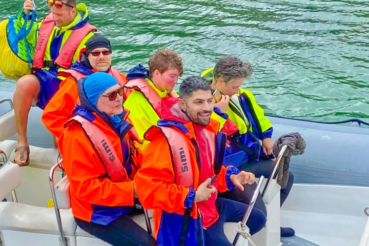 a group of people on a boat in the water