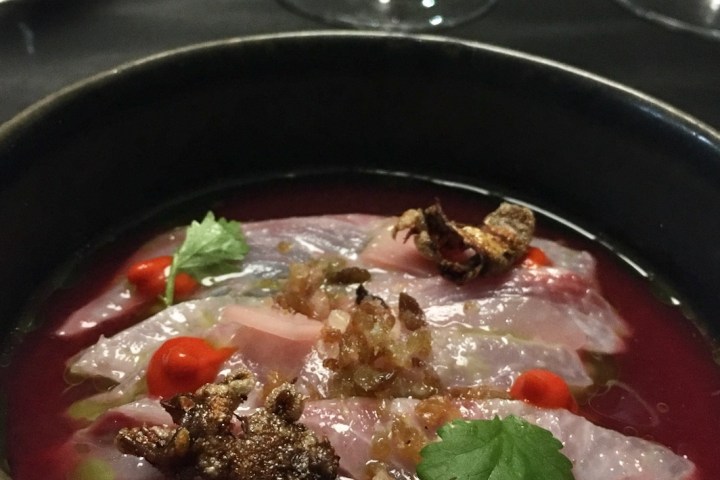 a bowl of soup with meat and vegetables on a plate