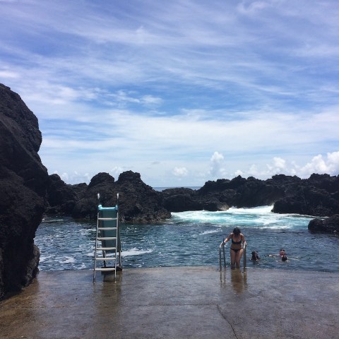 a group of people standing next to a body of water