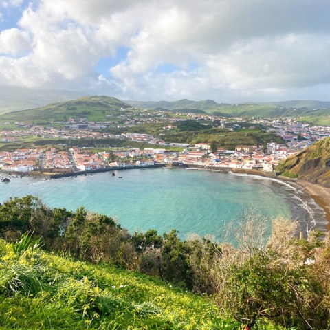 a body of water with a mountain in the background