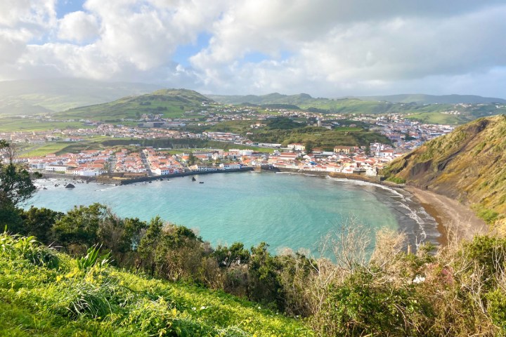 a body of water with a mountain in the background