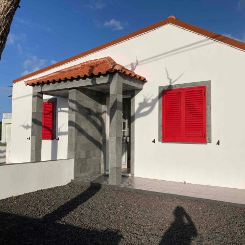 a house that has a sign on the side of a building