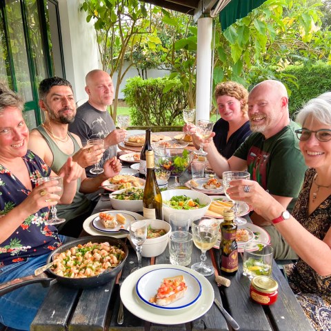 a group of people sitting at a table eating food