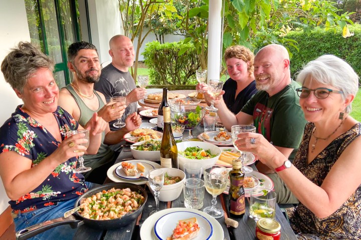 a group of people sitting at a table eating food