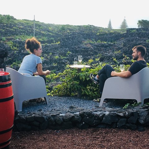 a group of people sitting on a rock