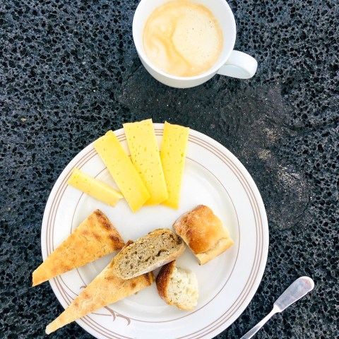 a plate of food and a cup of coffee