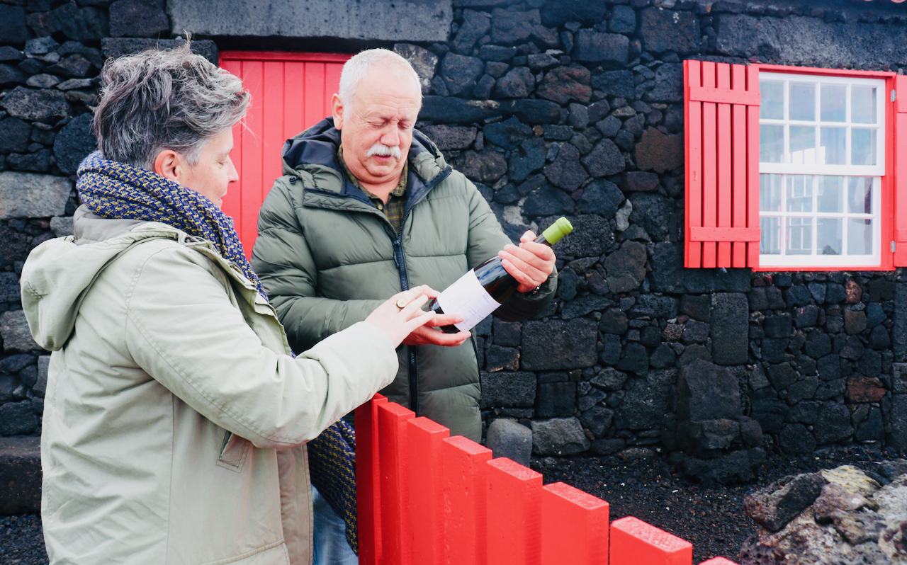 pico-wine-tour-azores a person standing in front of a brick wall