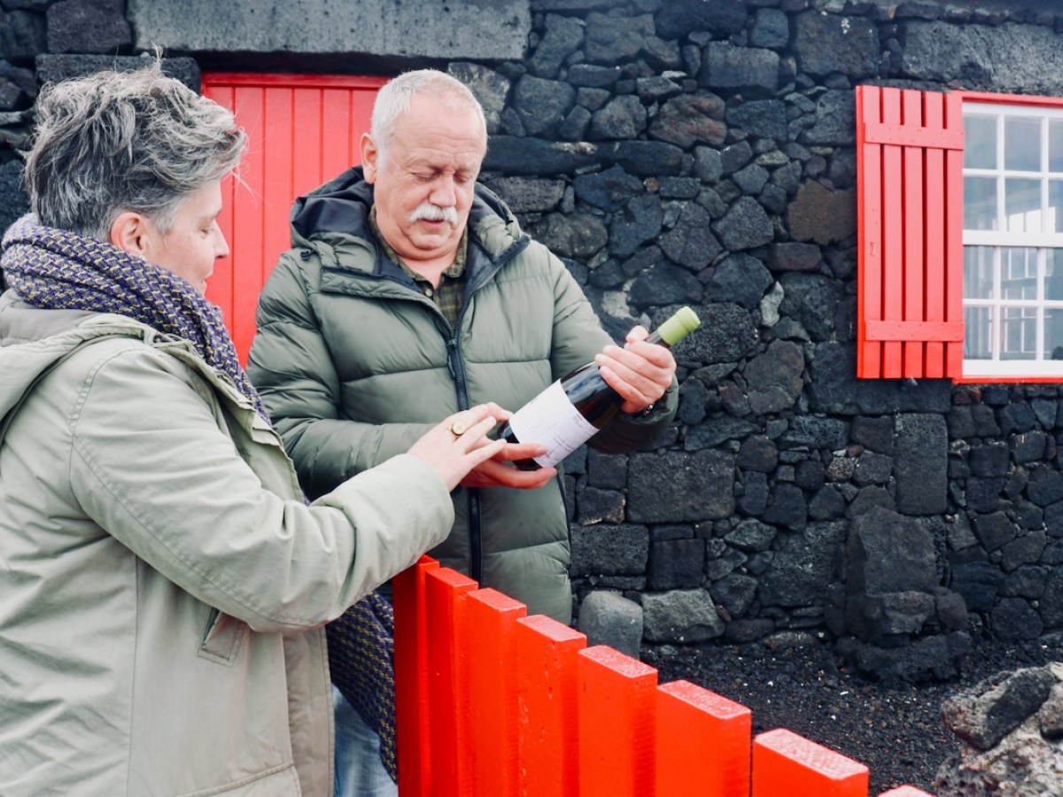 a person standing in front of a brick wall
