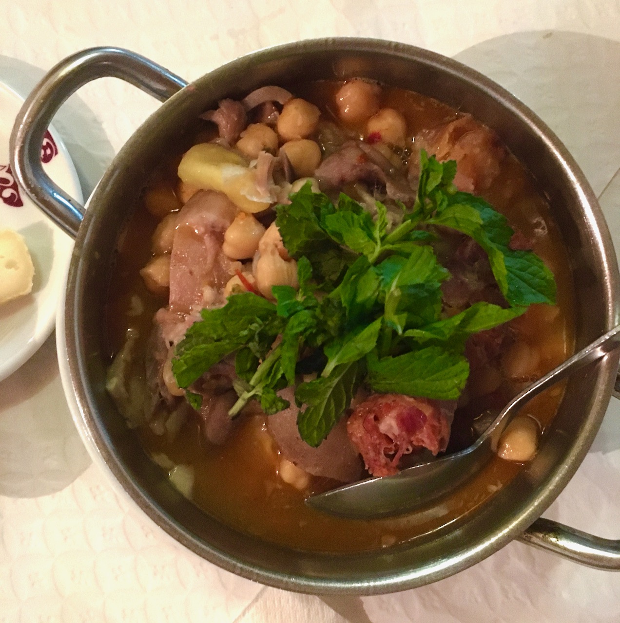 a bowl of soup with meat and vegetables