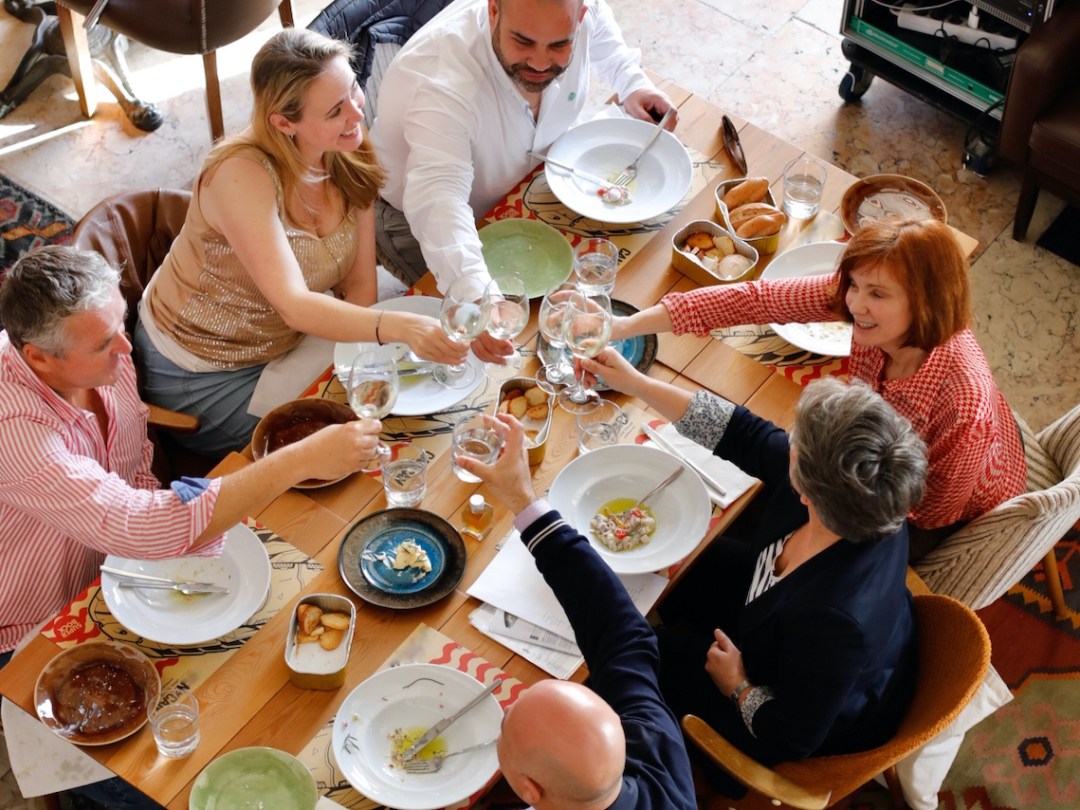 a group of people sitting at a table eating food