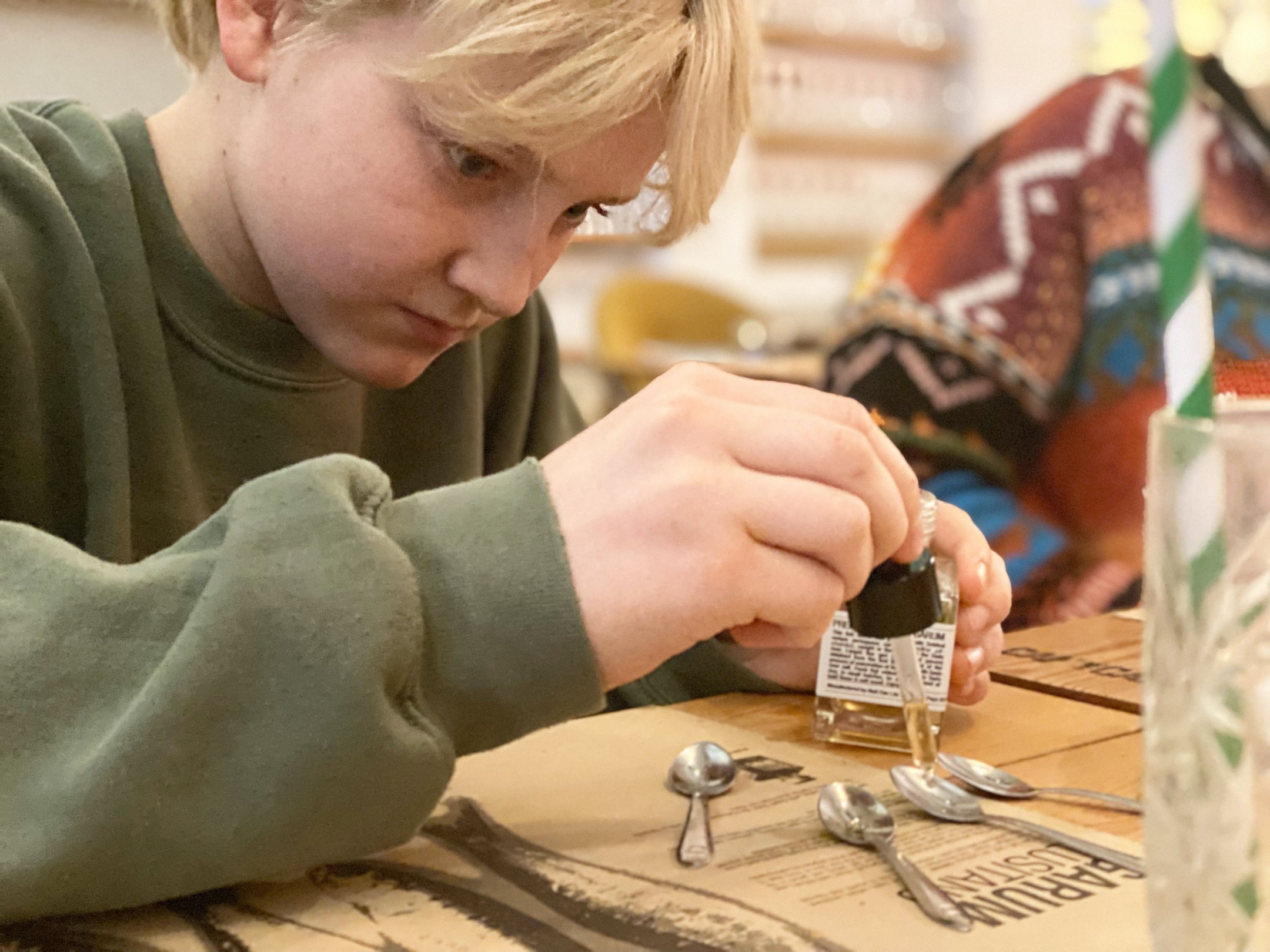 a person sitting at a table using a cell phone