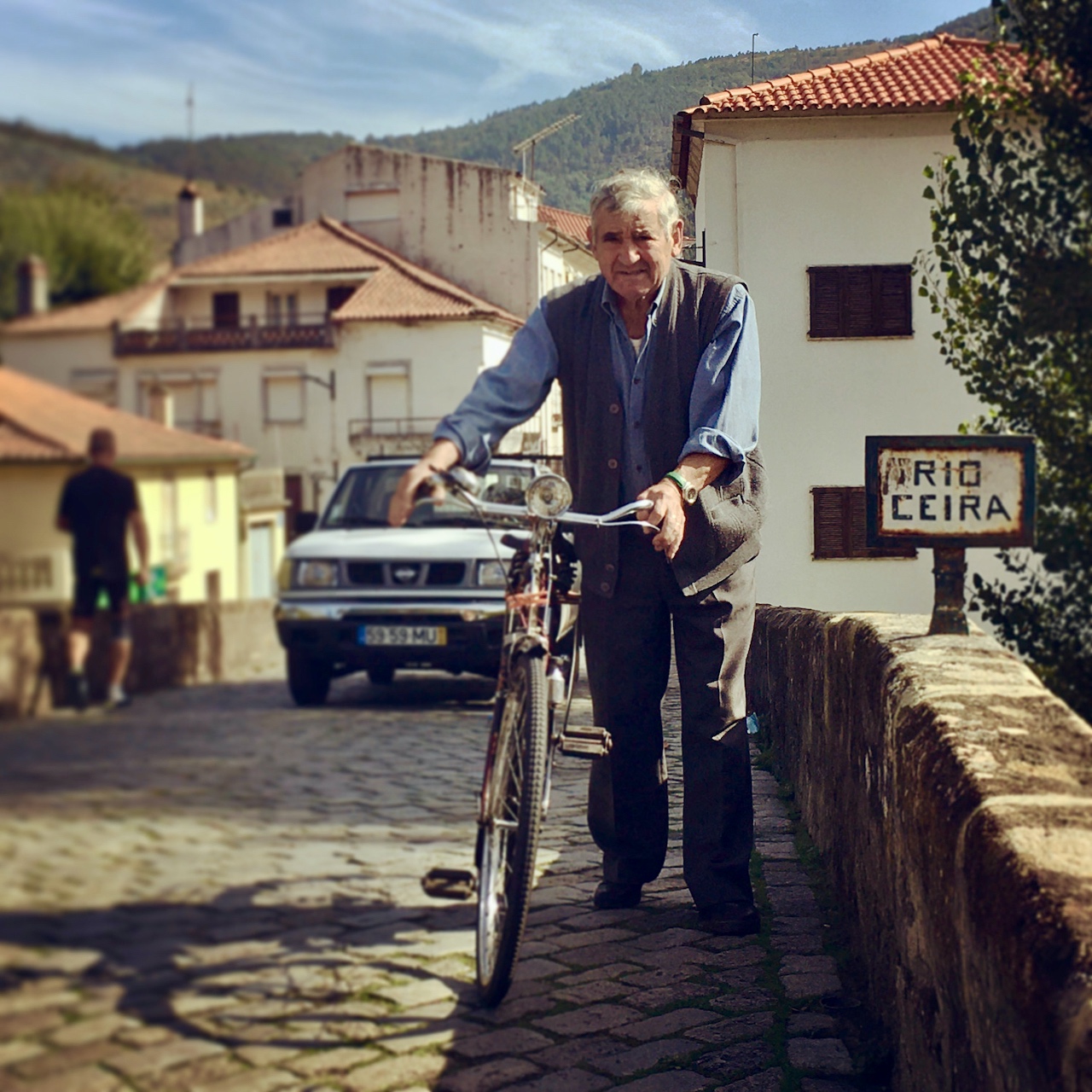 lousa-portugal-countryside a man standing in front of a building