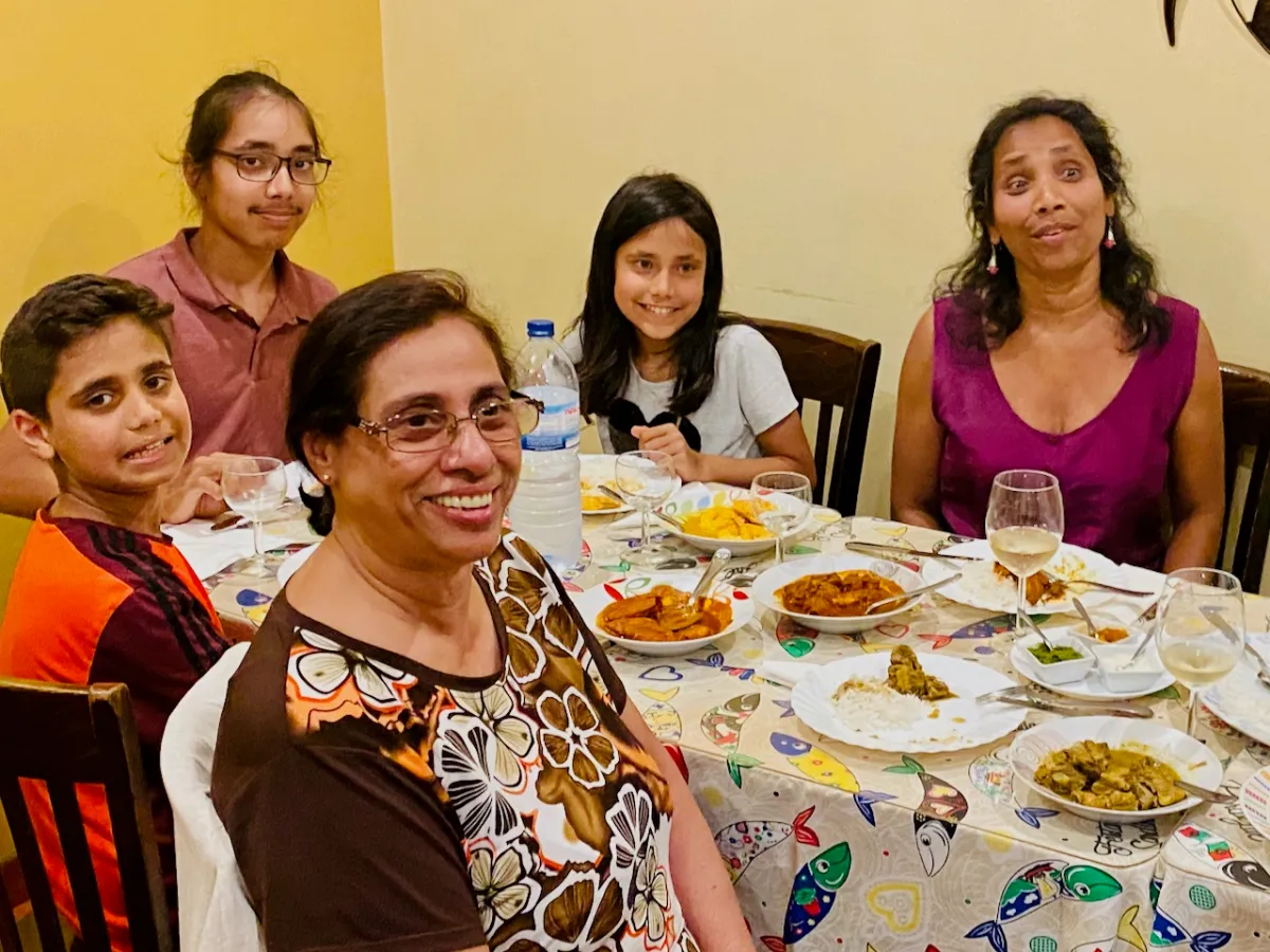 a group of people sitting at a table posing for the camera
