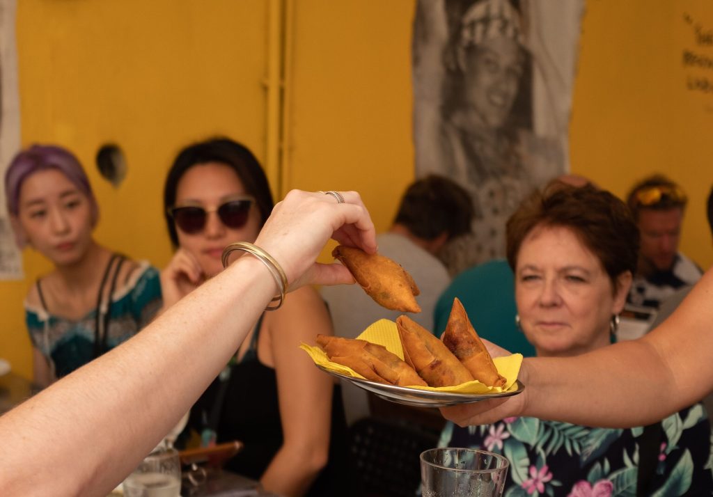 a group of people sitting at a table eating food
