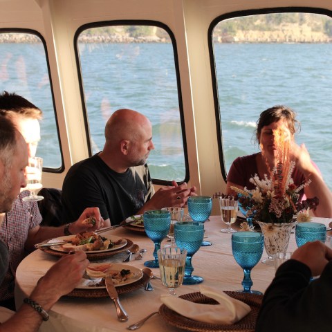 a group of people sitting at a table in front of a window