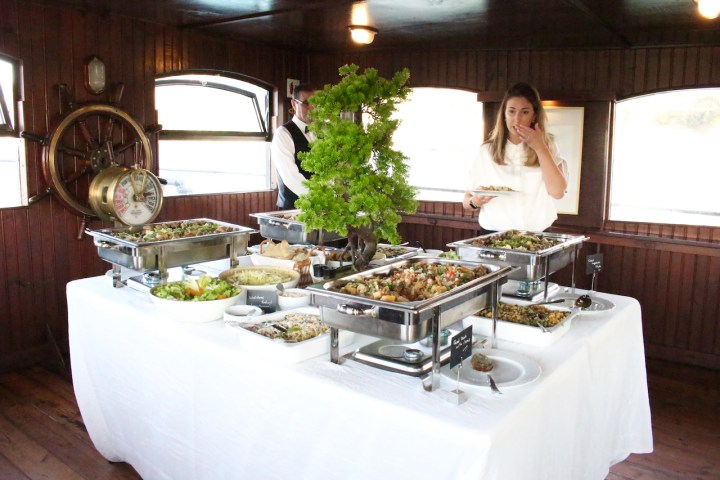 a person standing in front of a plate of food on a table
