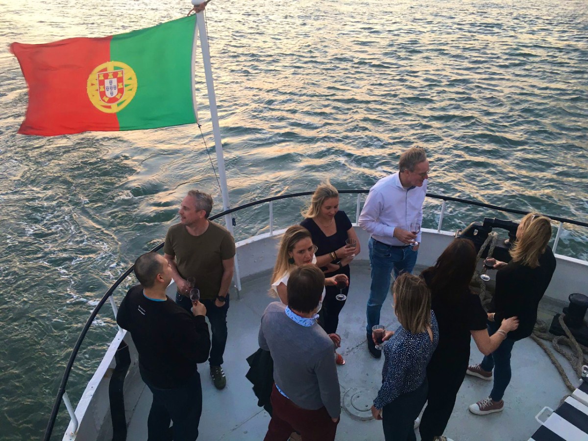 a group of people standing next to a body of water