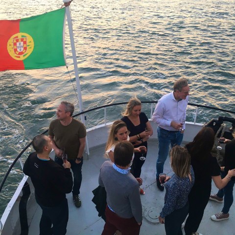 a group of people standing next to a body of water