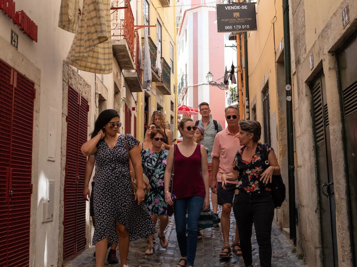 a group of people walking on a sidewalk